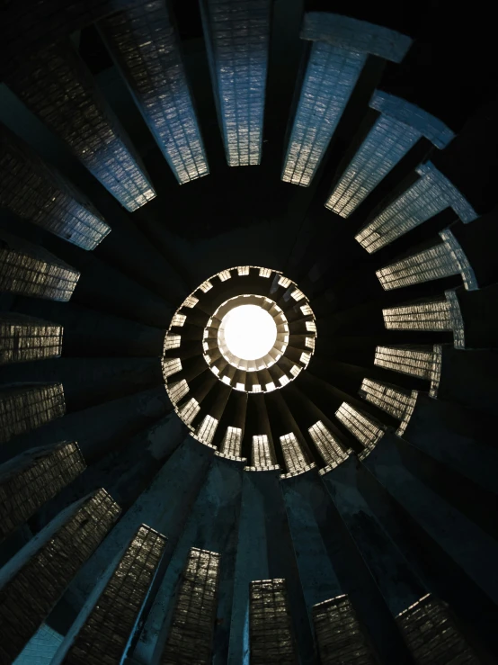 looking up at the inside of a large cylindrical window