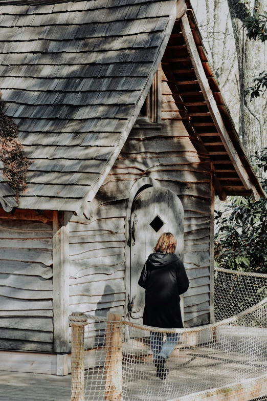 a person standing in front of a small building