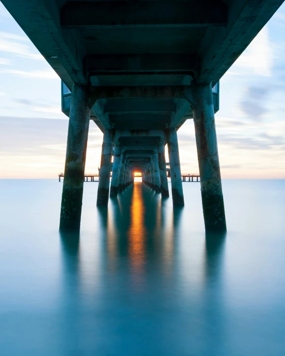 the view from underneath a bridge shows the water beneath