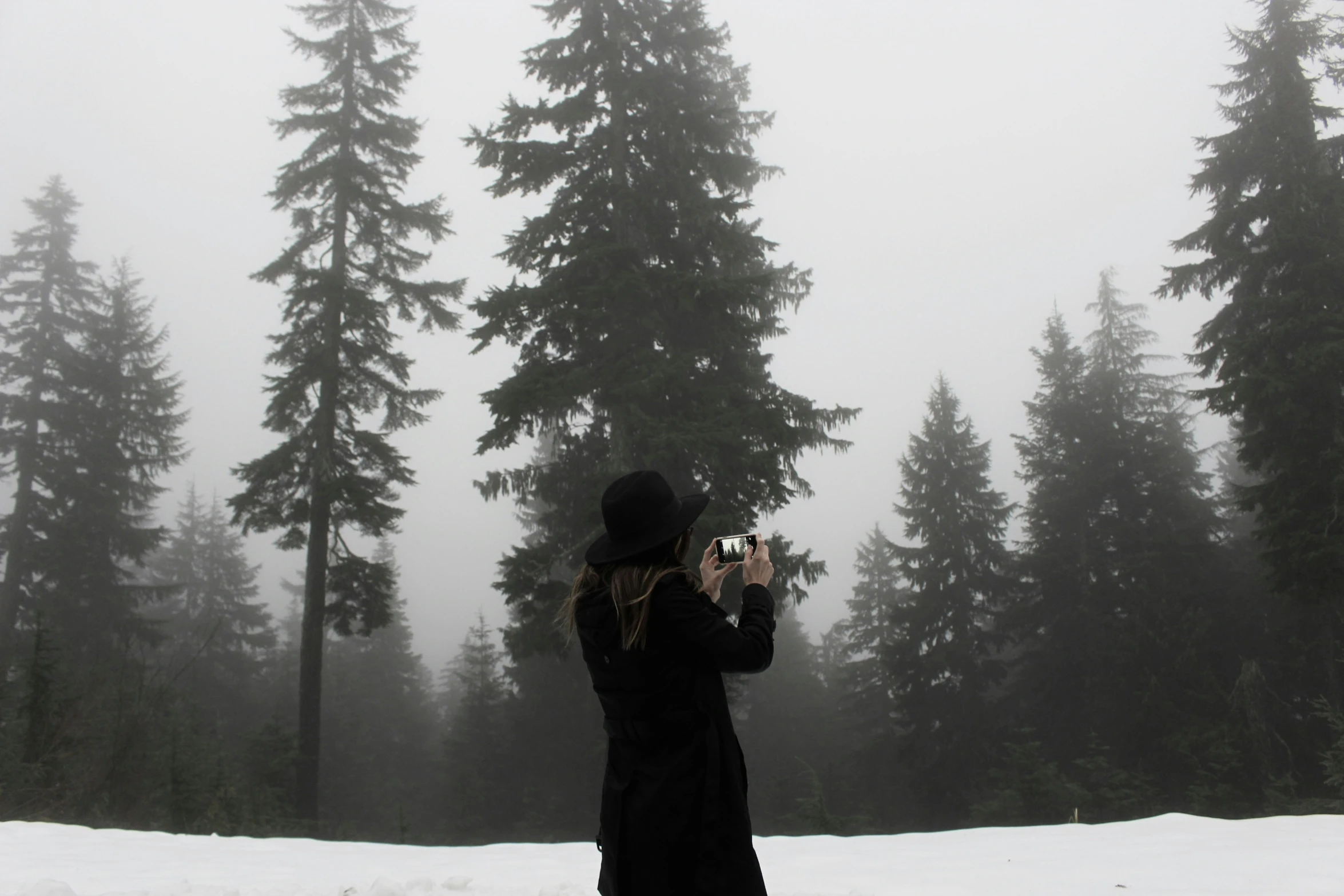 there is a woman taking pictures of the snow