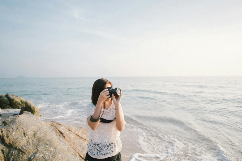 a woman is taking a po on the beach