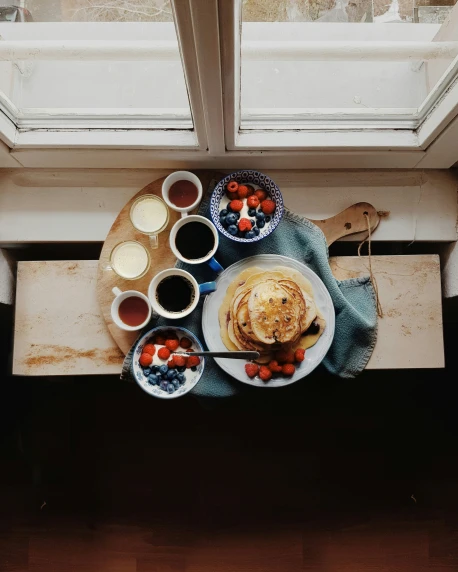 a breakfast on the table is displayed with berries