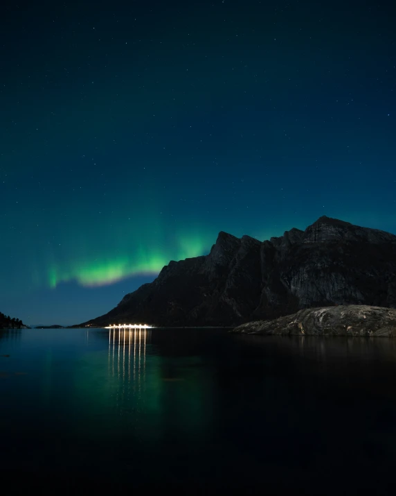 a body of water sitting below a green light