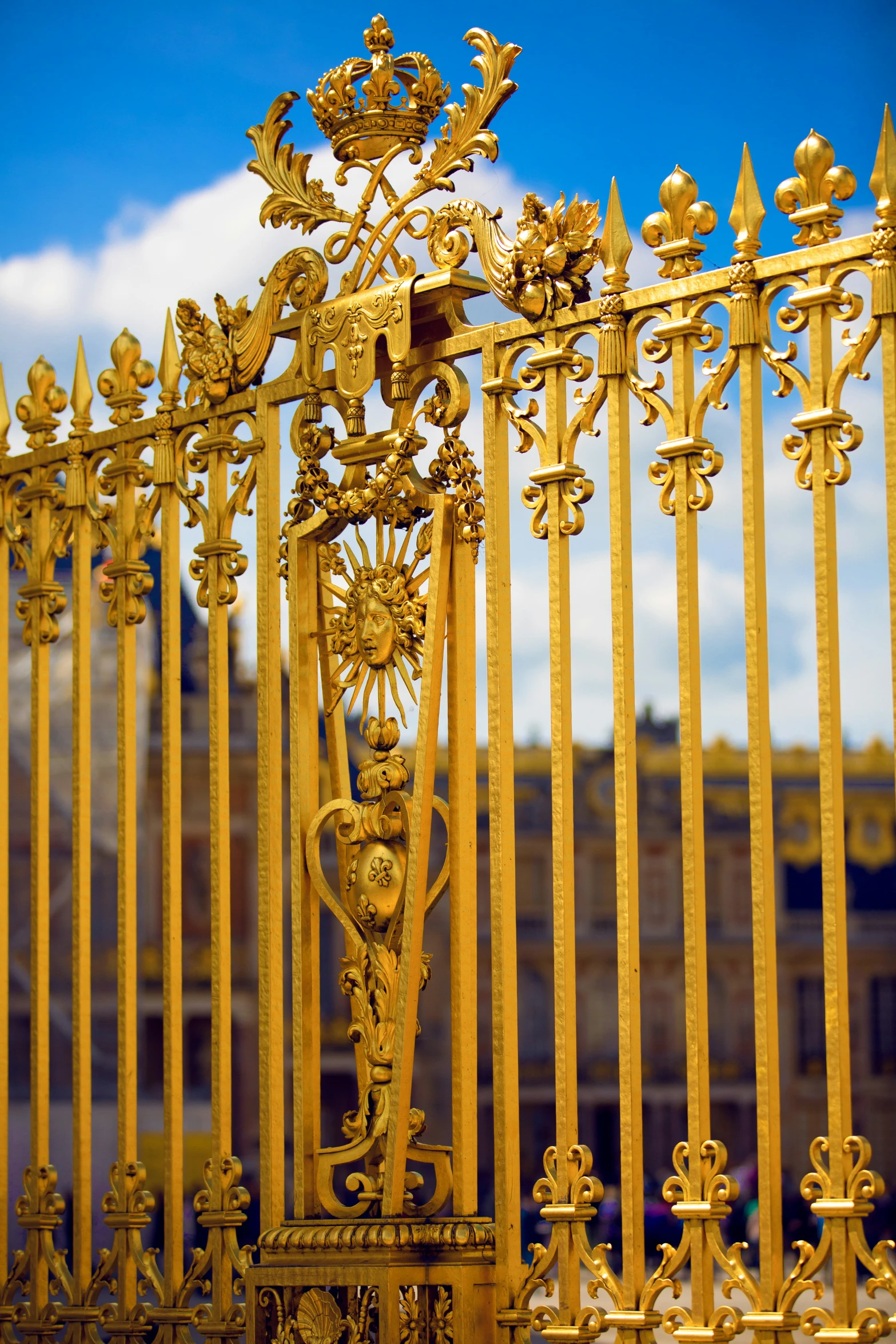 an ornate fence is shown with gilded gold metal