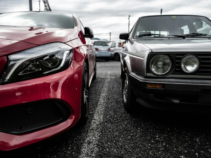 two cars parked close to each other on the parking lot