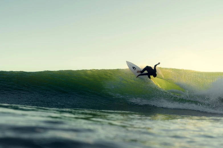 a man in the air on a surfboard riding a wave