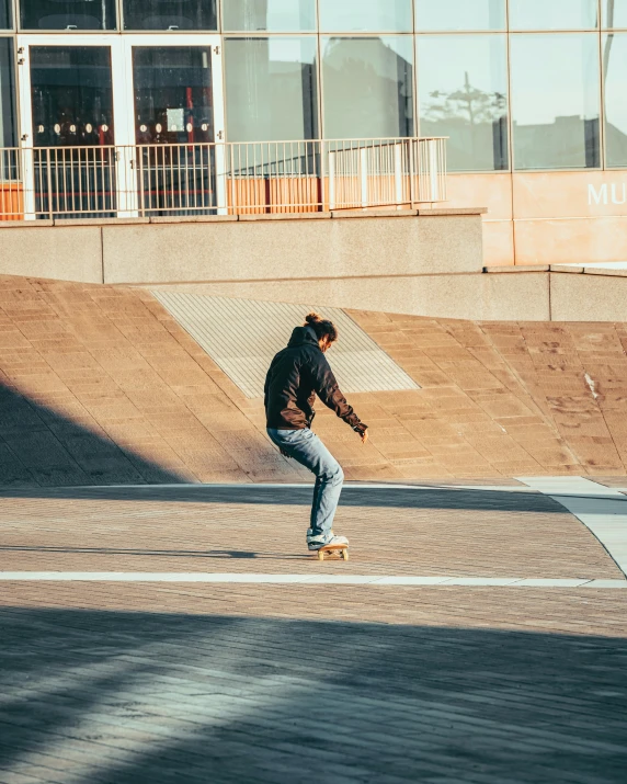 there is a man riding his skate board on a street