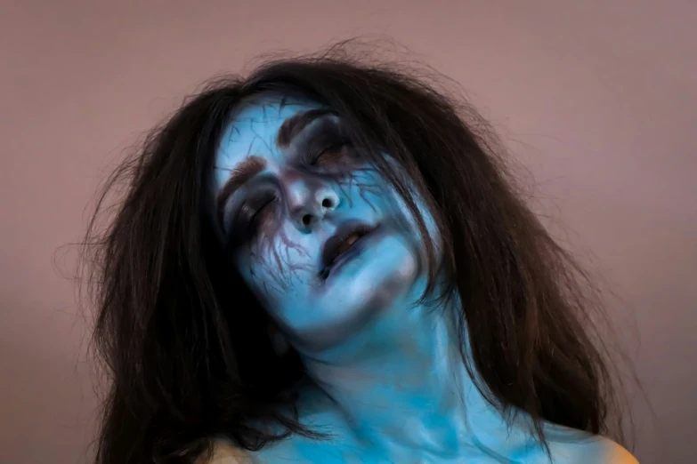 woman with make up and blue paint all over her body