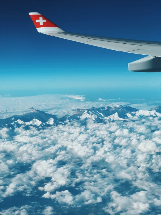 view of airplane wing and clouds in flight