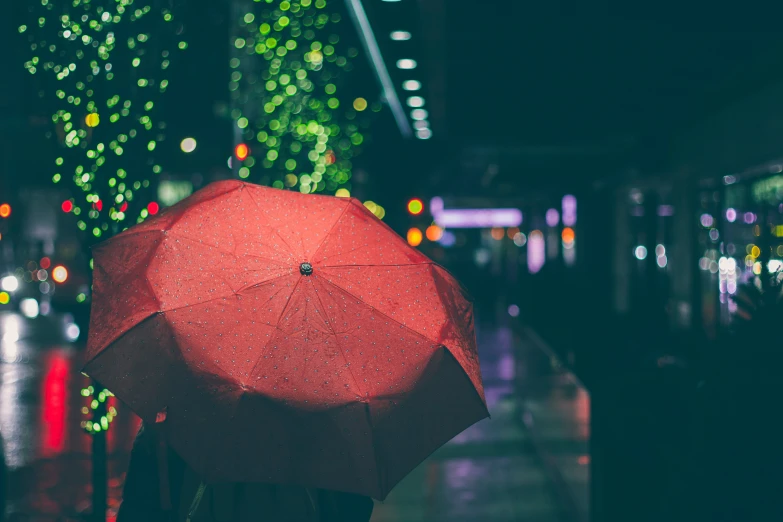 an umbrella on the street that is red in color