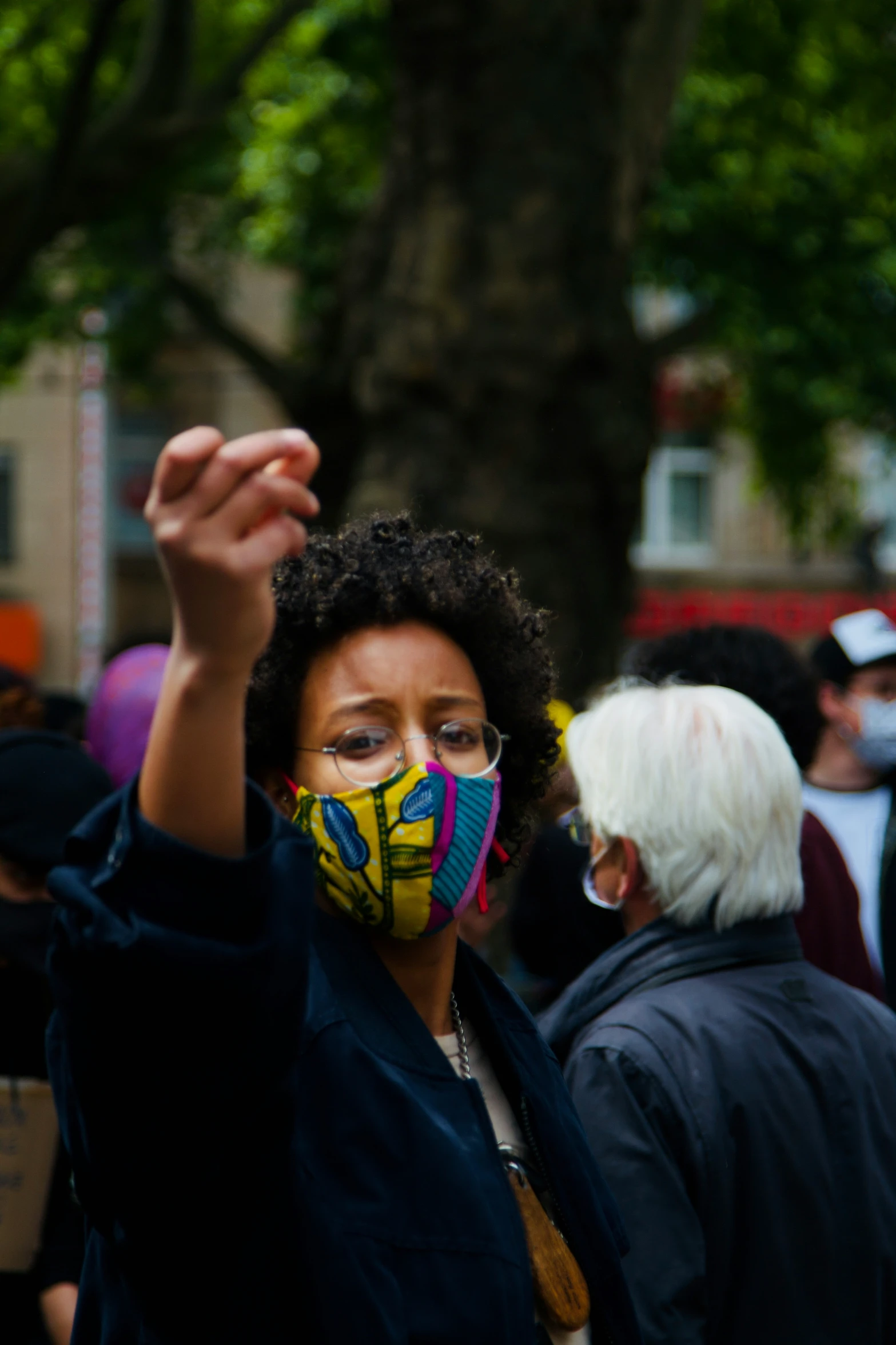 there is a person wearing a mask and giving a peace sign