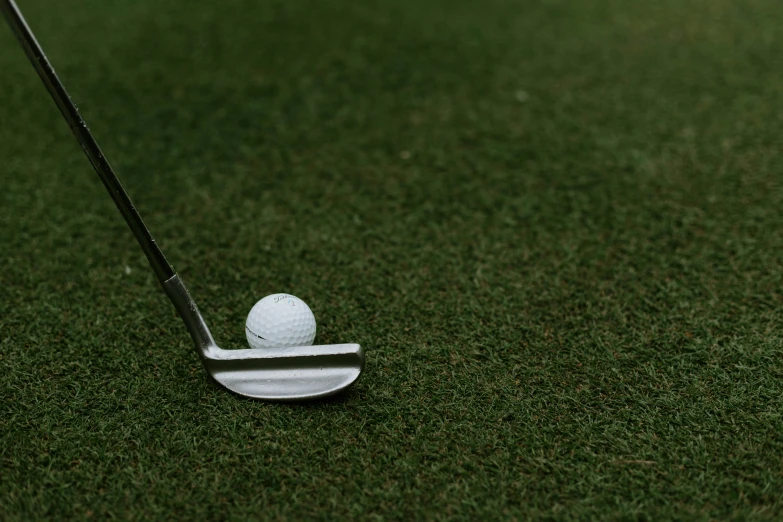 a white golf ball on the green grass