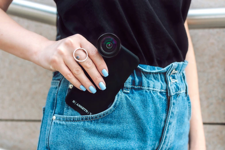 a woman wearing denim shorts and a black shirt