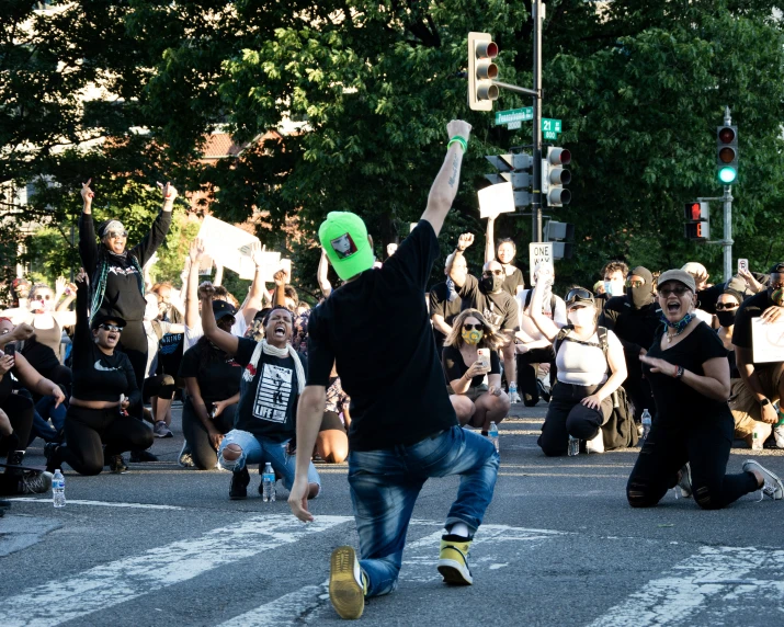 the man is running while holding up a sign with the people behind him