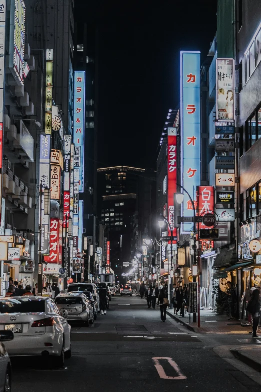 an oriental city at night with neon lights and business signs