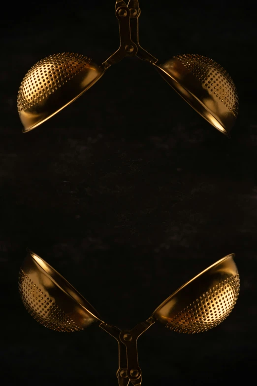 gold bells are displayed against a black background