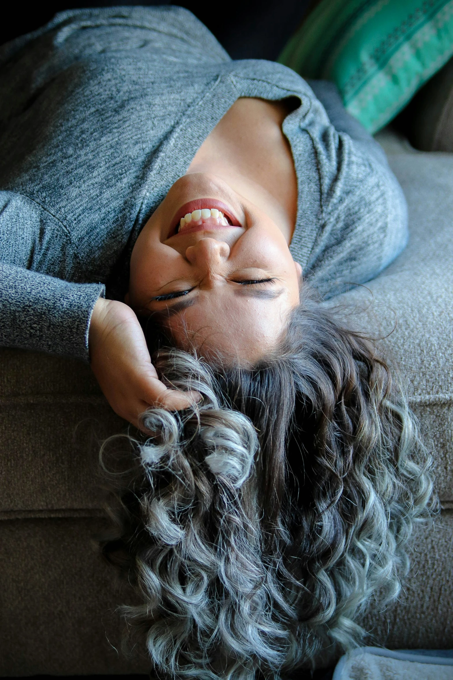 a small child is lying on the couch while taking a nap