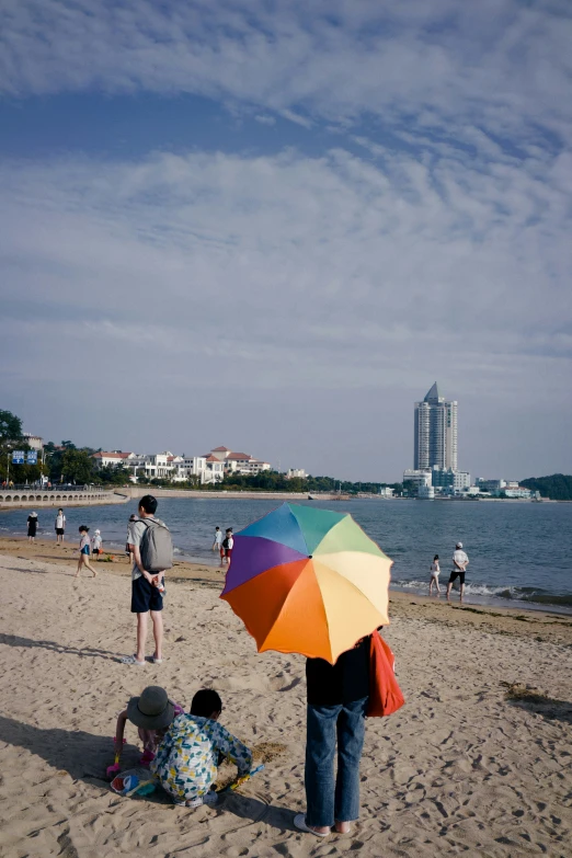 two people at the beach with an umbrella