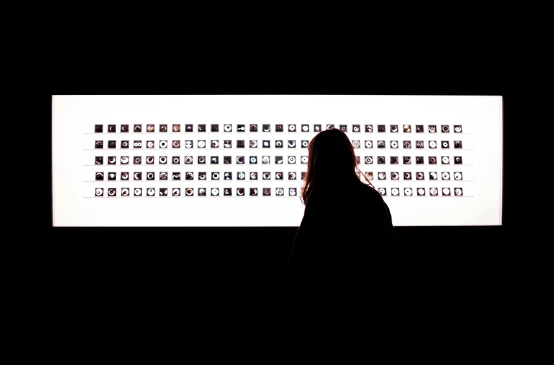 a person standing in front of a white wall