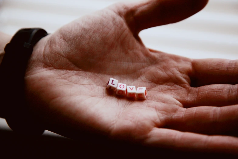 small cube beads in the palm of someone's hand