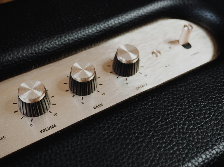 the controls on an old amplifier with black leather