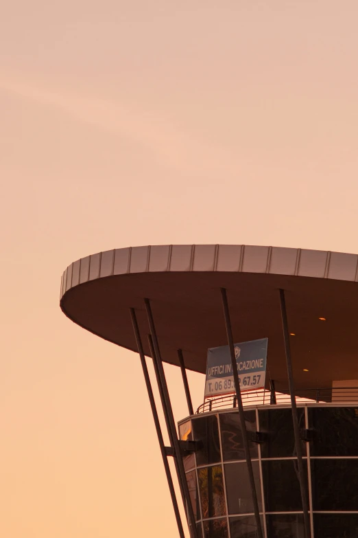 an airplane flying low over a large building