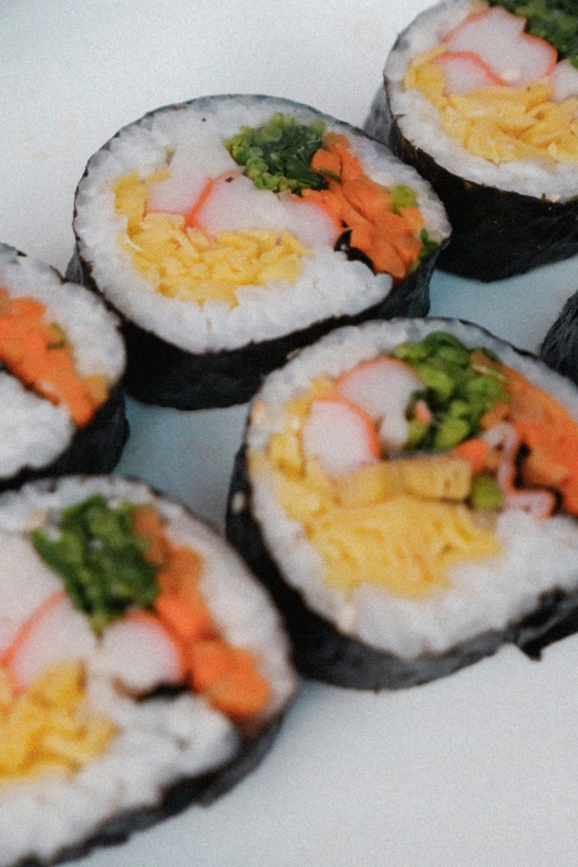 sushi is sitting on top of a white plate