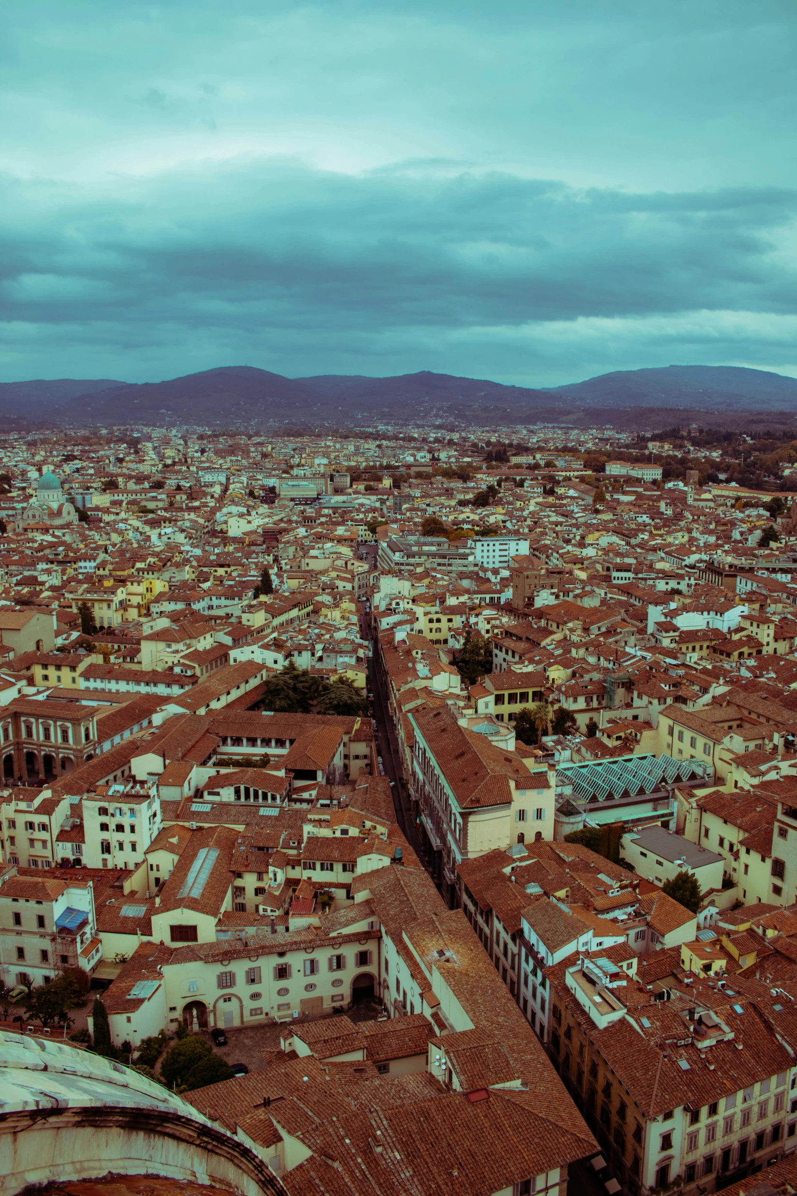 an aerial view of a city in the middle of a cloudy day