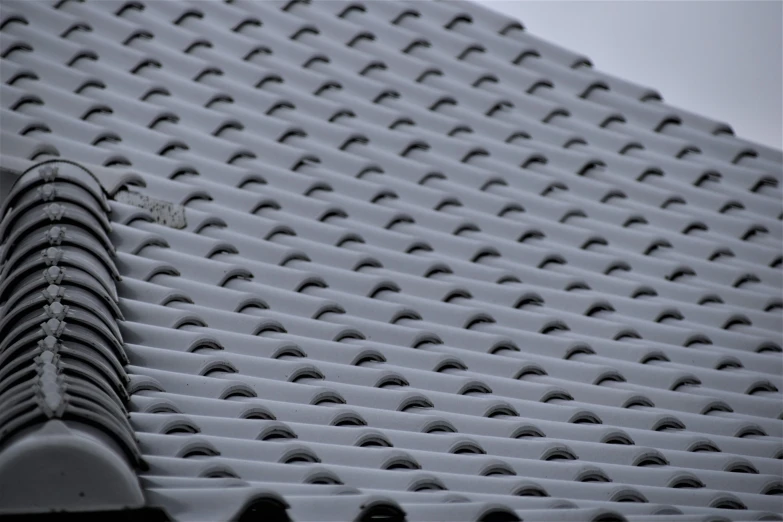 a building has snow on the roof with skis in the air