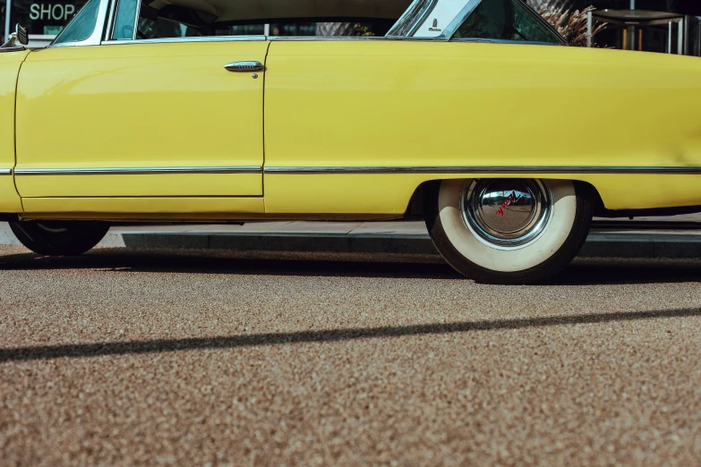 an older car is parked on the side of the street