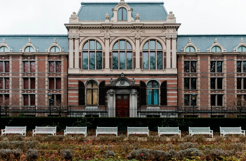 a brick building with many windows on the front of it