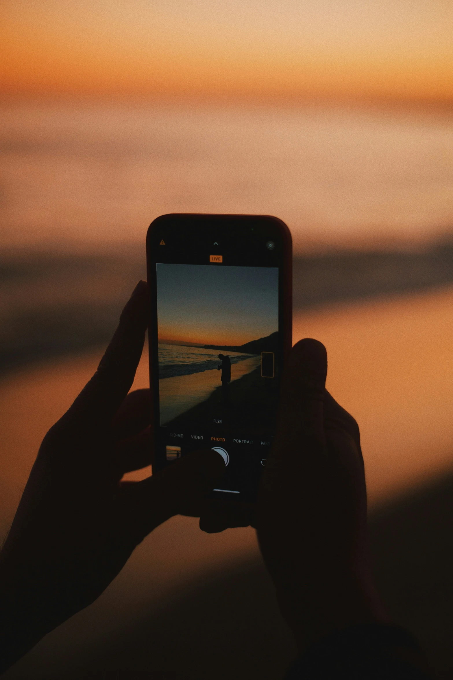 a person taking a picture with their cell phone