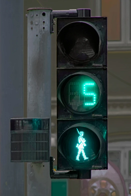 a green traffic light that has the word do not walk painted on it