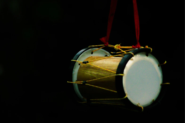 a close up of a drum ornament hanging