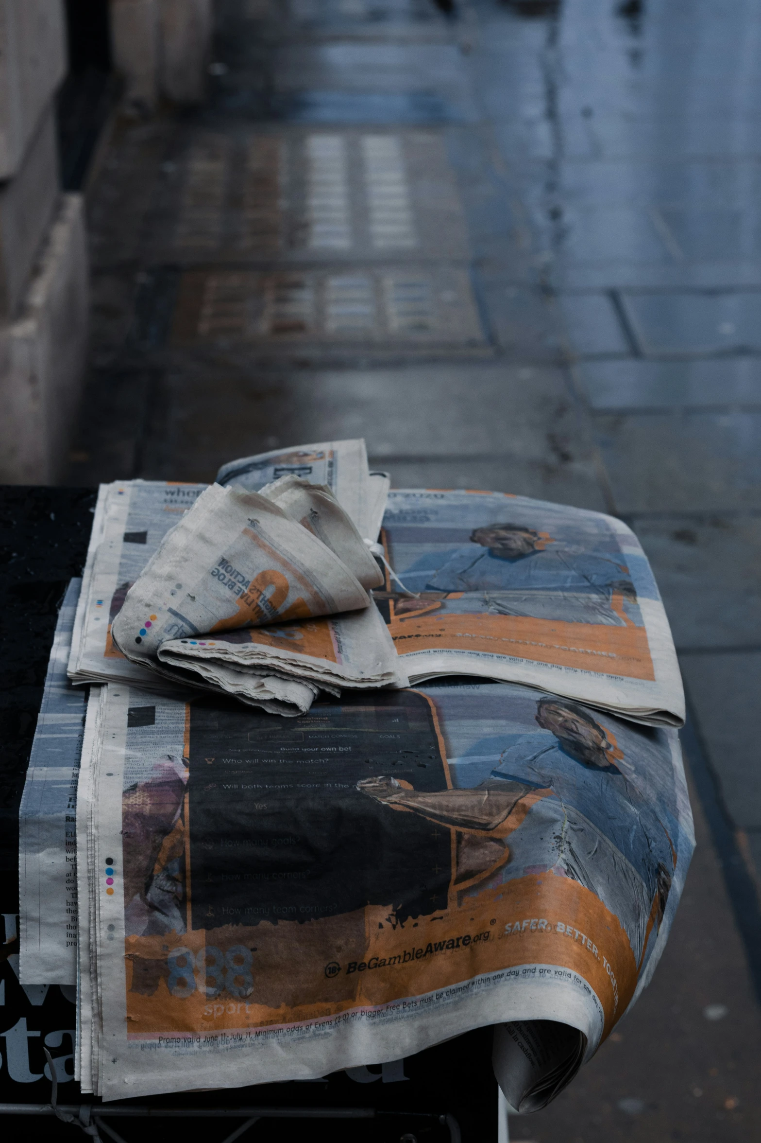 newspaper with news paper folded on it sitting outside