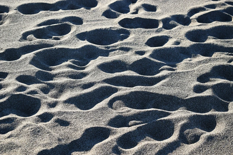 patterns of sand and footprints on the beach