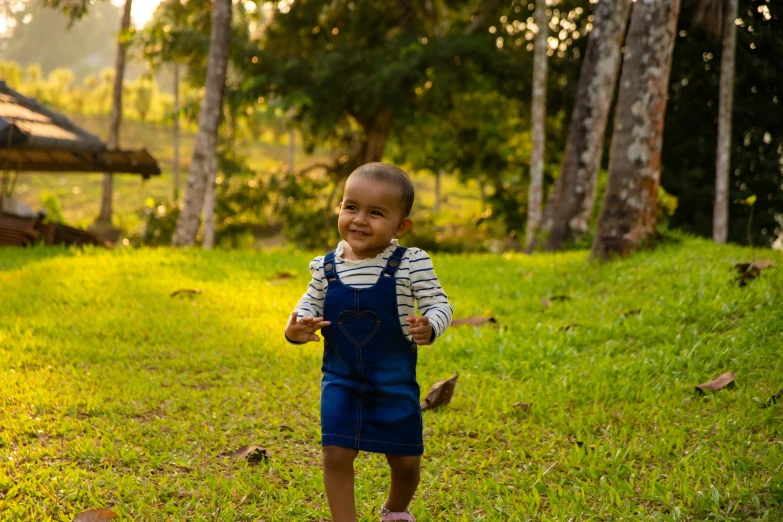 an adorable child running in the green grass