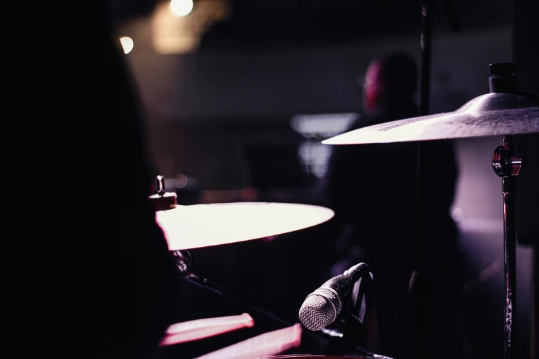 drums are shown in dark room with light