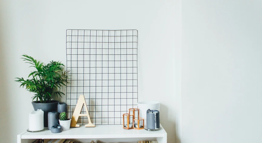 a table with a plant, a decorative letter and some other items