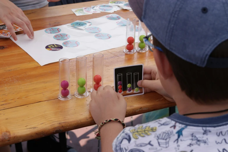 a  is playing with some colorful candy beads