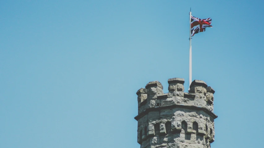 an old castle with a flag flying on top of it