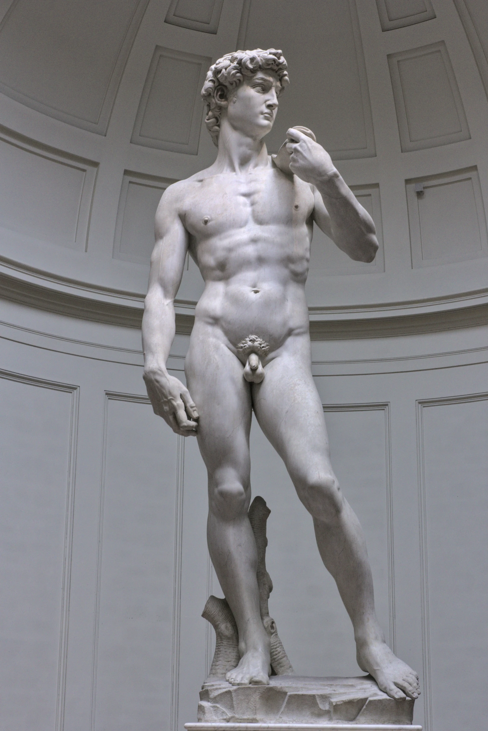 a statue of a male torso in the middle of a room