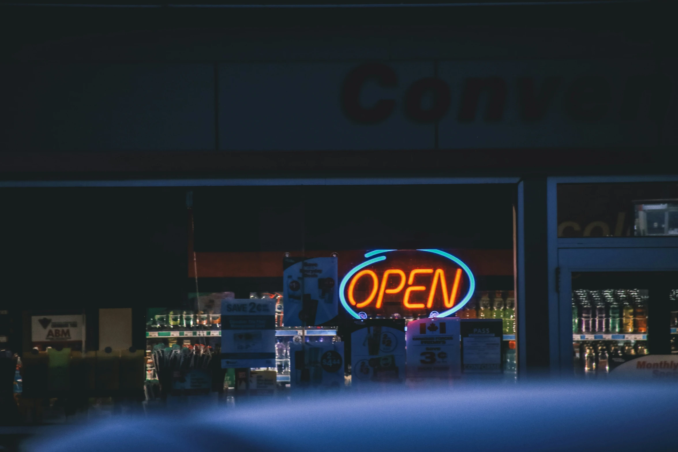 a store that is open at night with neon lights