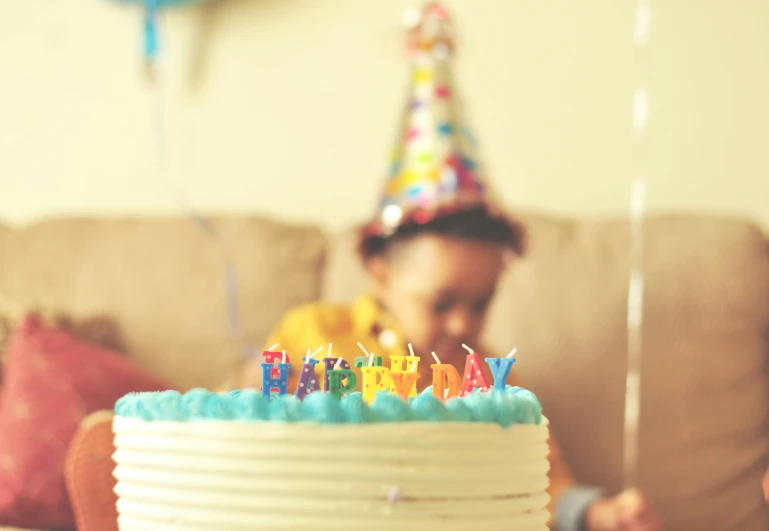 a  blows out the candles on his birthday cake