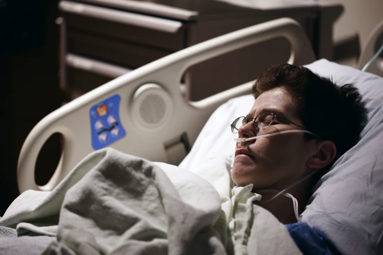 a man laying in a hospital bed next to a patient