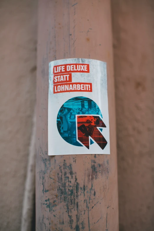 sticker on a brown pole of some sort