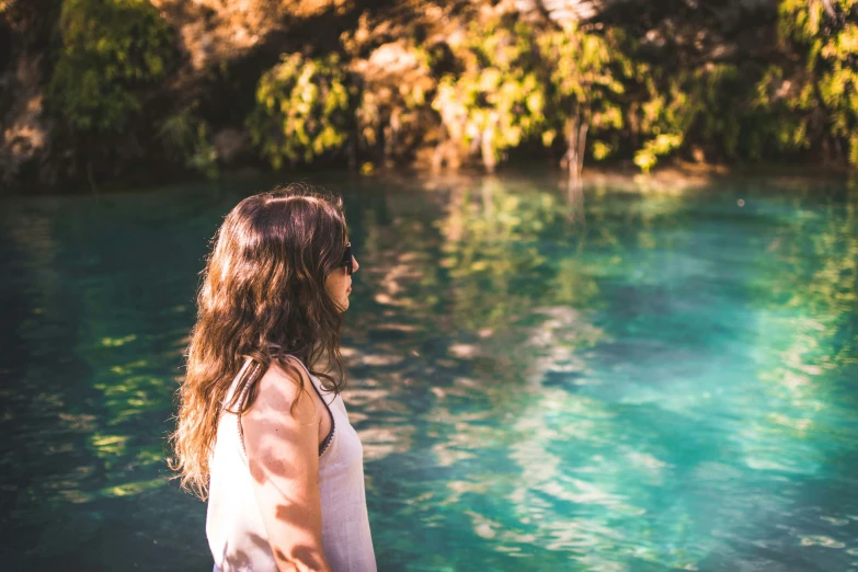 a girl staring off into the water