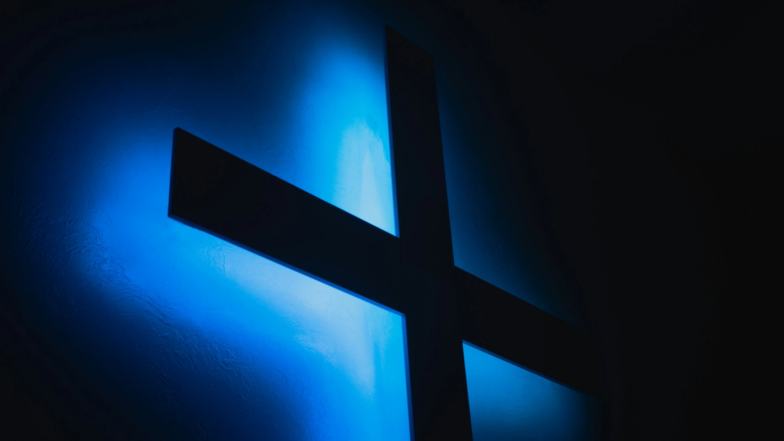 a blue lit object sits in the dark