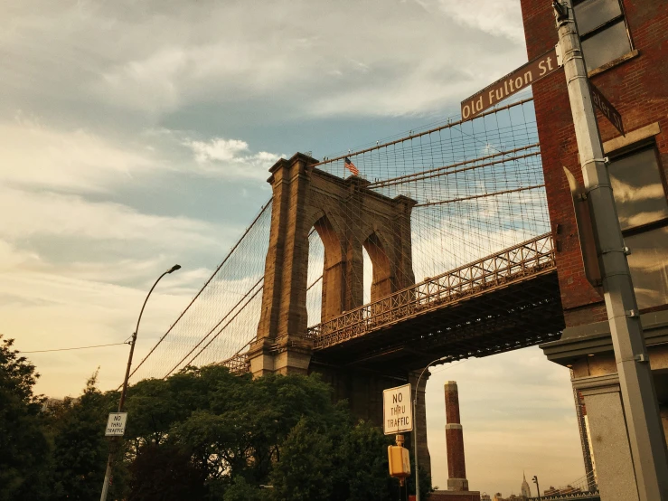 the bridge with the pedestrian railing over it is under cloudy skies