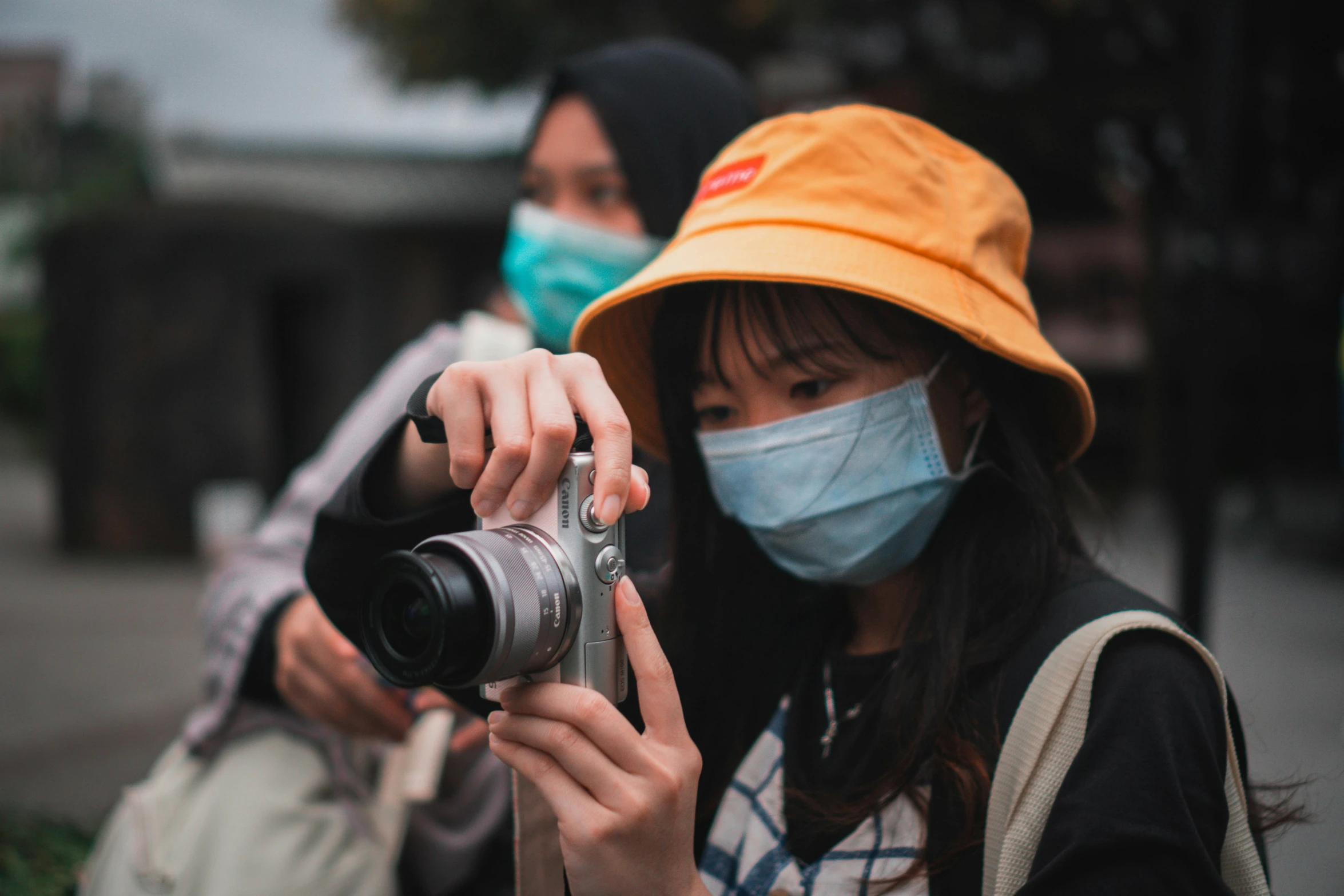 two people holding a camera taking pos